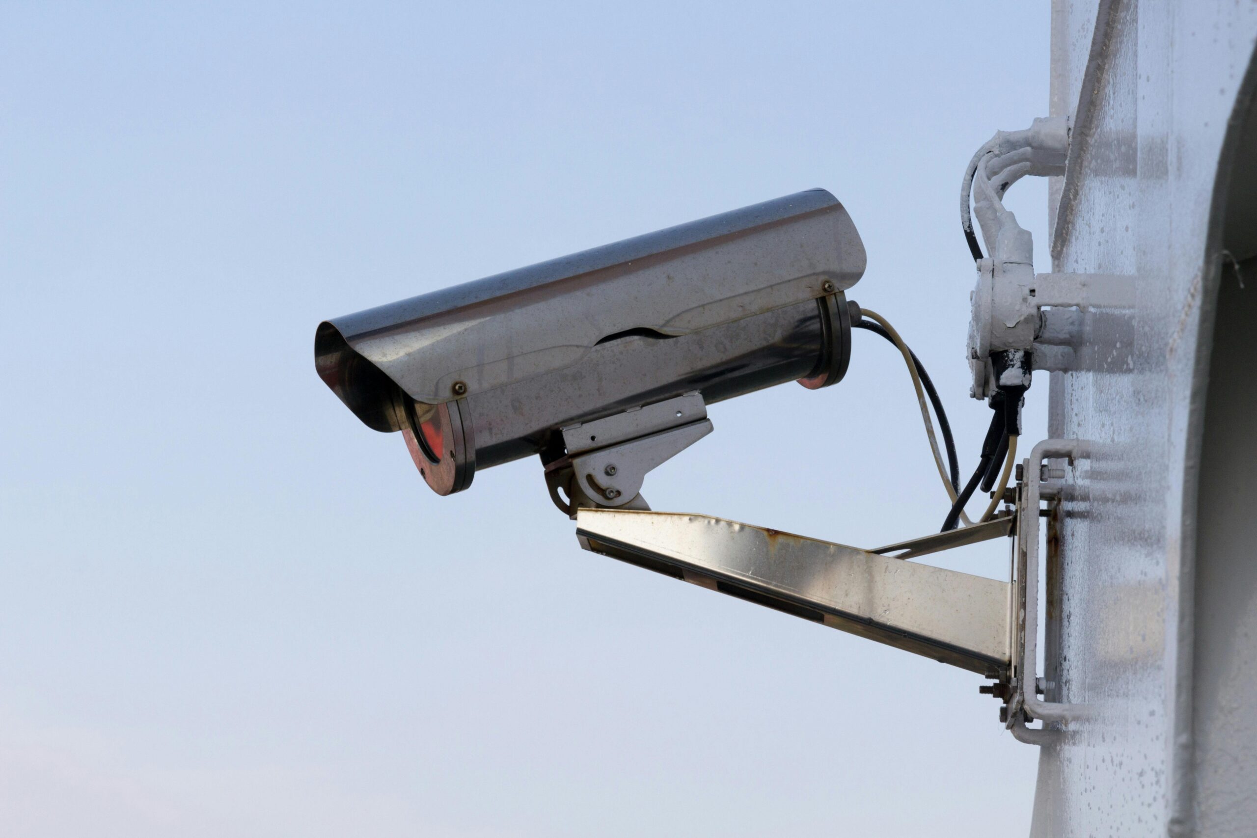 Outdoor bullet camera on a wall mount, showing business security camera features like weatherproof housing