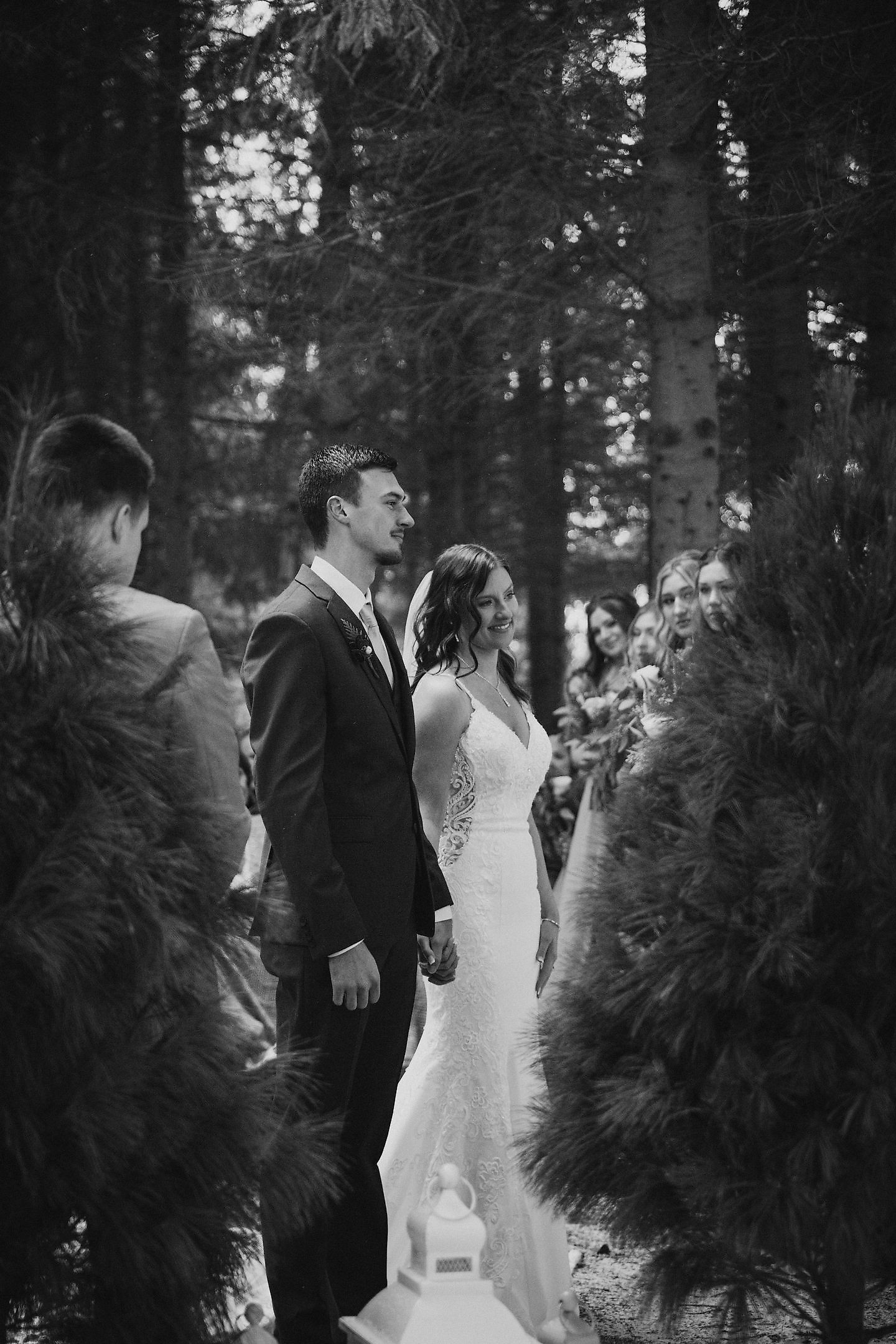 Black and white photography of a bride and groom at their winter wedding in northern Michigan. The bride is wearing the Lizzie gown by Morilee, designed by Madeline Gardner. This gown was purchased at Pierre's Bridal, Prom, and Tuxedo. This bridal shop is only about an hour and a half drive from Grand Rapids and Ann Arbor.