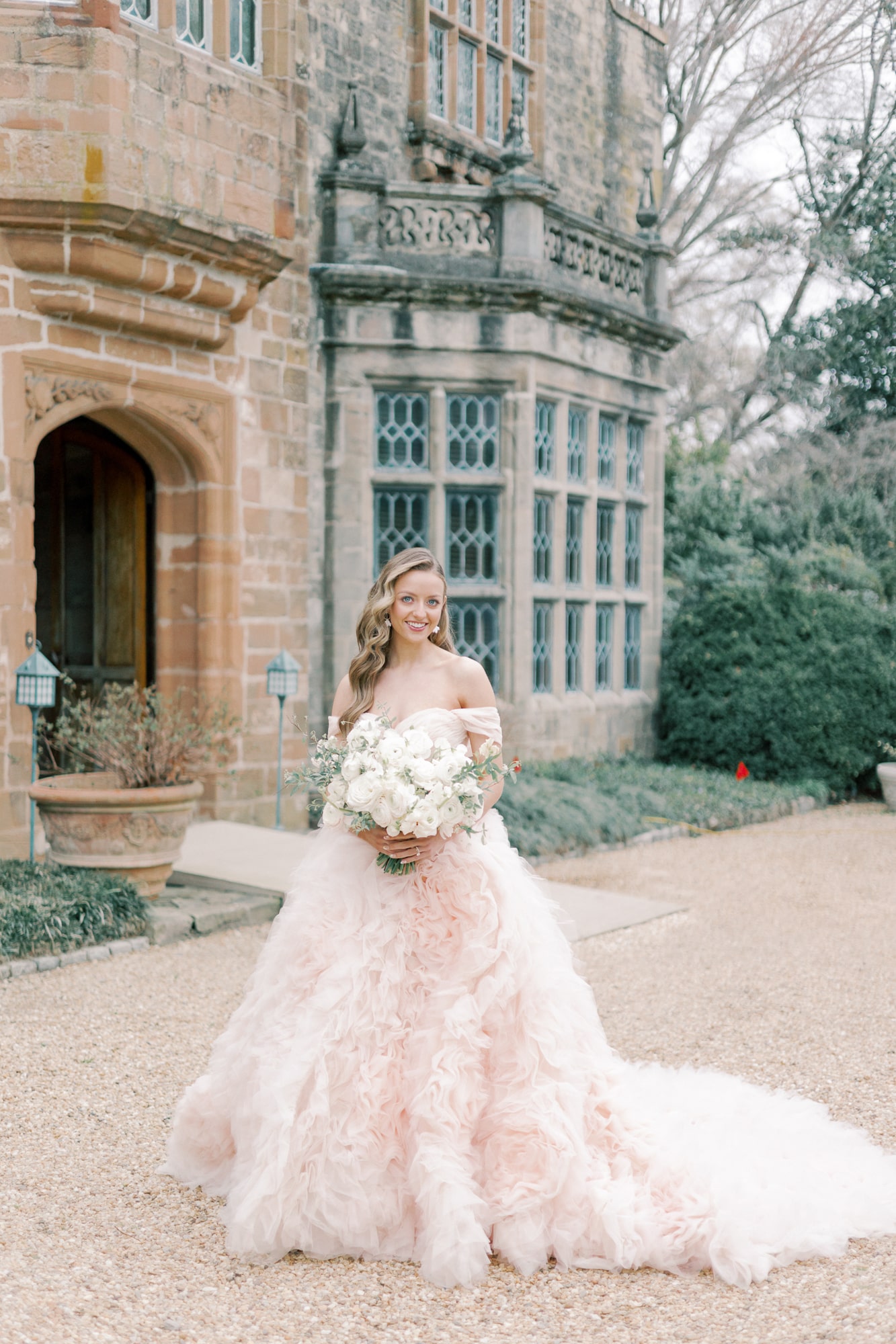 The Josefina gown by Morilee, available at Pierre's Bridal, Prom, & Tuxedo, a bridal shop in Lansing, Michigan. The Josefina gown is a blush pink wedding dress covered in tulle rosettes. This pink ballgown is the focal point of this dreamy fairytale wedding, featuring pastel flowers and a castle venue at the Virginia House.
