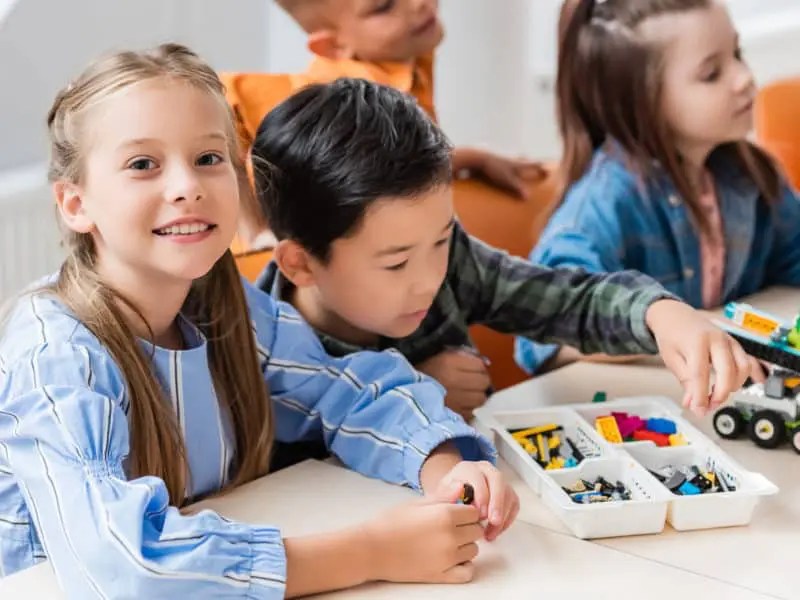 Children building with Lego engineering kits
