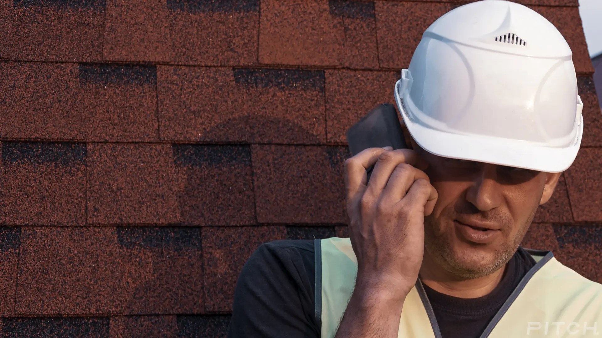 Local roofer taking a call