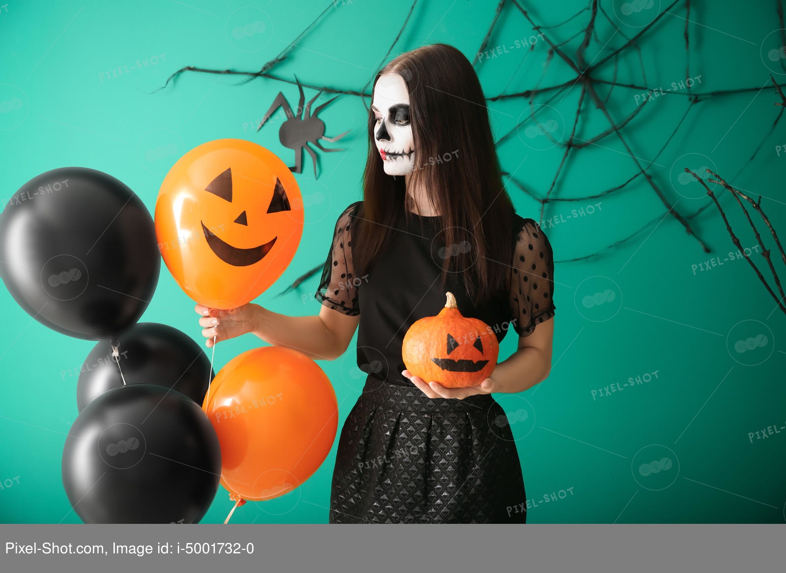 These festive luminarias brighten the night. Beautiful Woman Dressed For Halloween With Pumpkin And Balloons Standing Near Decorated Wall Stock Photography Agency Pixel Shot Studio