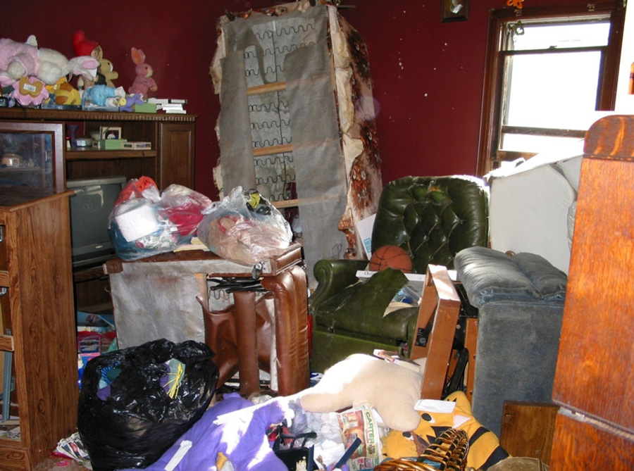 Piles of junk and rotting food greeted Erie police officers and FBI agents when they searched Marjorie Diehl-Armstrong’s house after September 21, 2003. They were looking for evidence that she fatally shot her boyfriend Jim Roden and helped place his body in a freezer in Bill Rothstein’s garage. Diehl-Armstrong had history of hoarding government-surplus food. "I’ve dealt with corpses with the flesh falling off. This is worse," a veteran Erie police officer said of Diehl-Armstrong’s house. FBI photo, used as evidence at trial