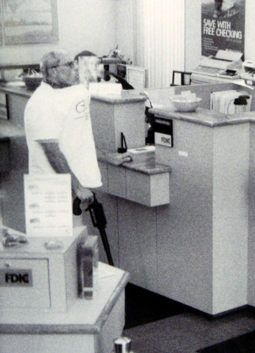 Brian Wells stands at the front counter of the PNC Bank in the Summit Towne Centre, waiting for the chief teller to give him money on August 28, 2003. He had asked for $250,000, an extraordinary amount for a bank robbery. RICH FORSGREN/ERIE TIMES-NEWS, via FBI