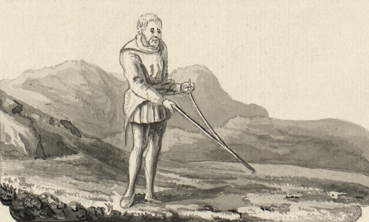 image of a man holding a forked stick as a divining rod