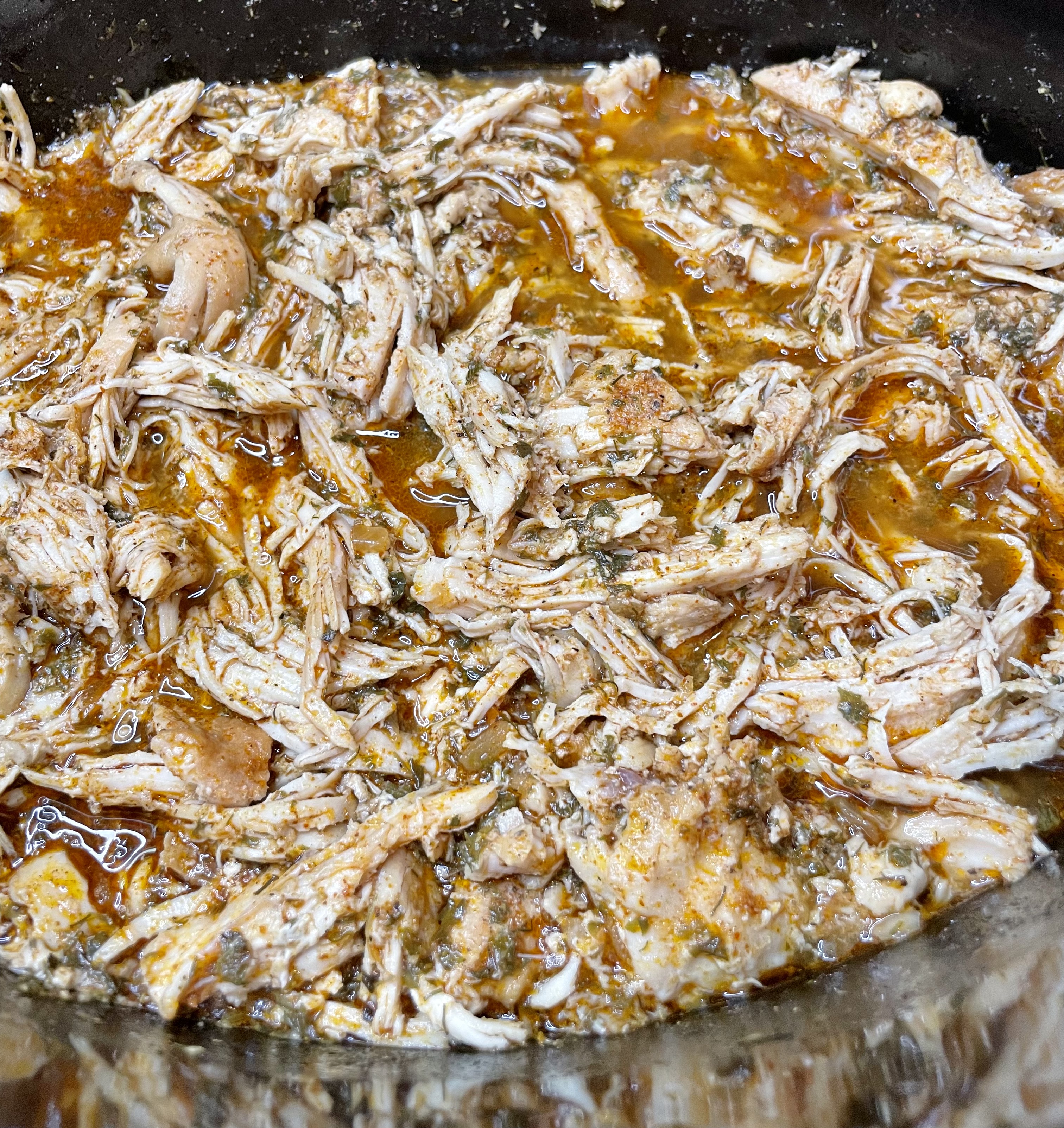 Shredded cool ranch crock pot chicken in a crock pot, ready to serve in tacos or wraps.