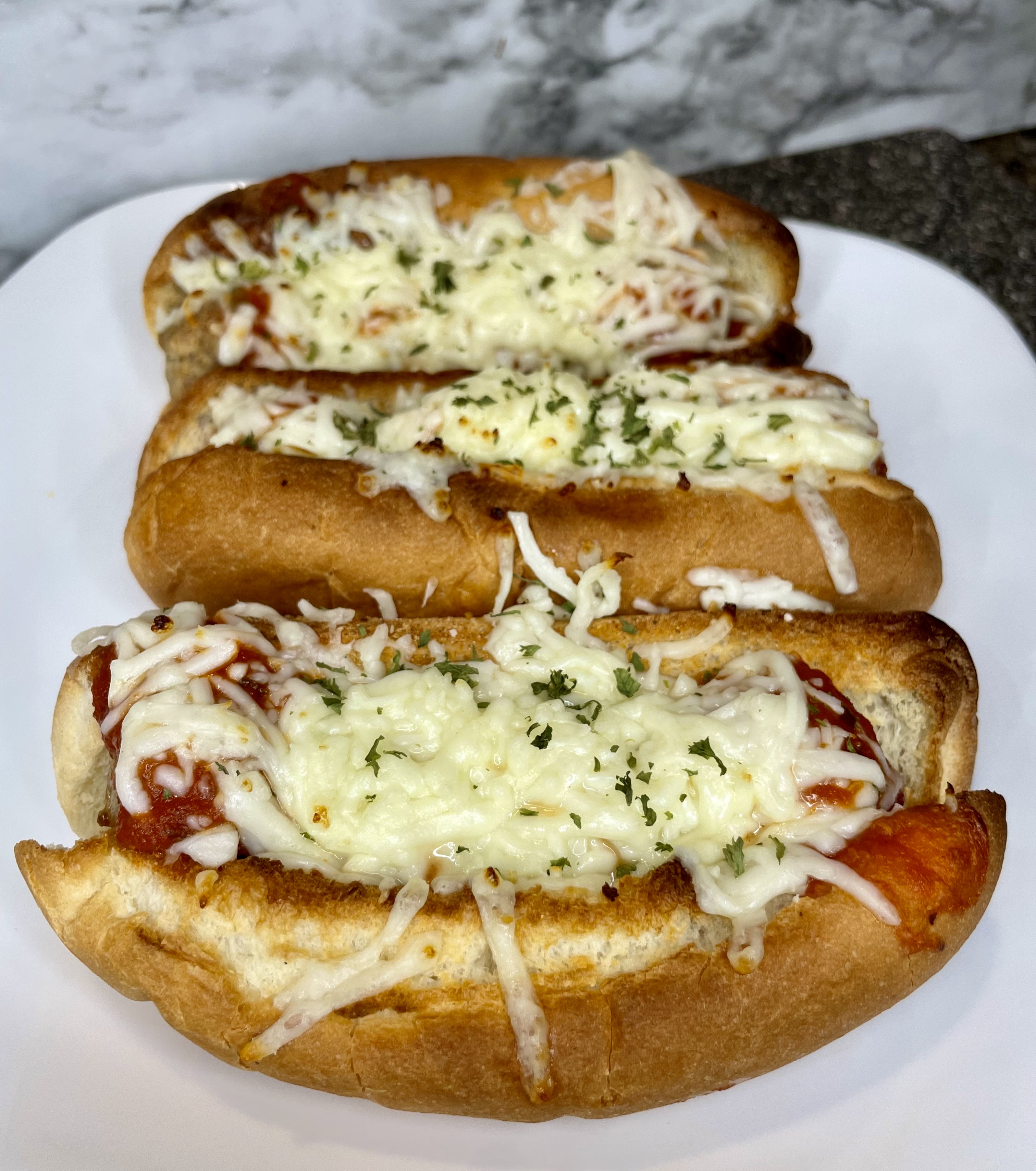 Mozzarella covered meatball sub on a plate