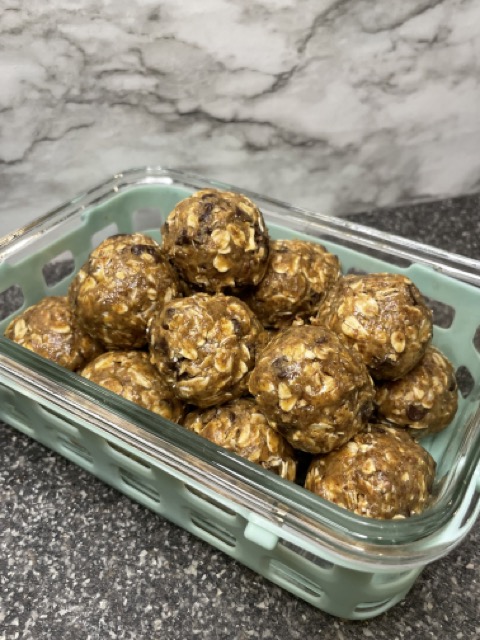 No bake energy bites in a pile, chocolate, peanut butter, and oatmeal.