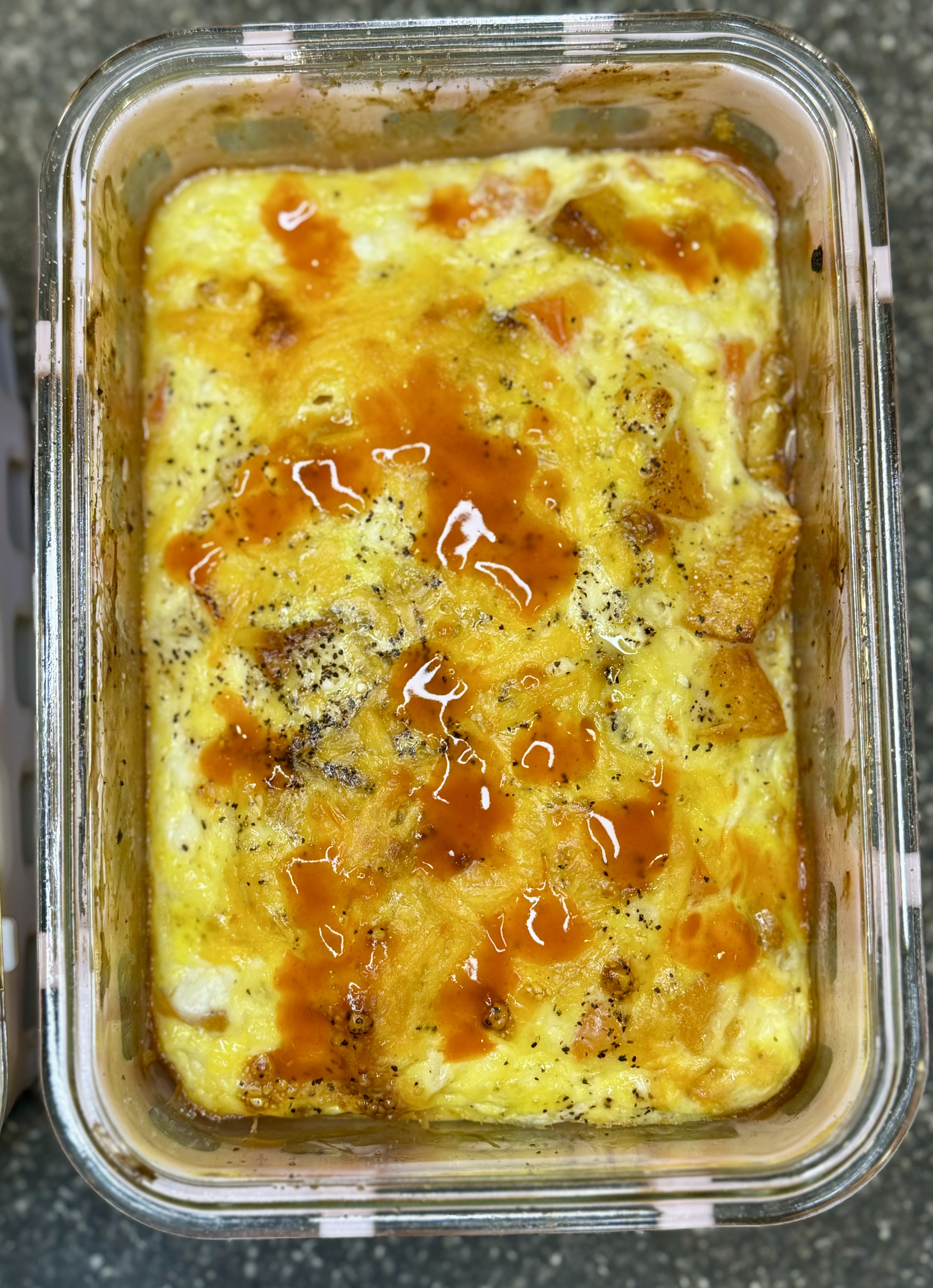 A cozy breakfast bowl with roasted butternut squash, baked eggs, cottage cheese, and vegetables