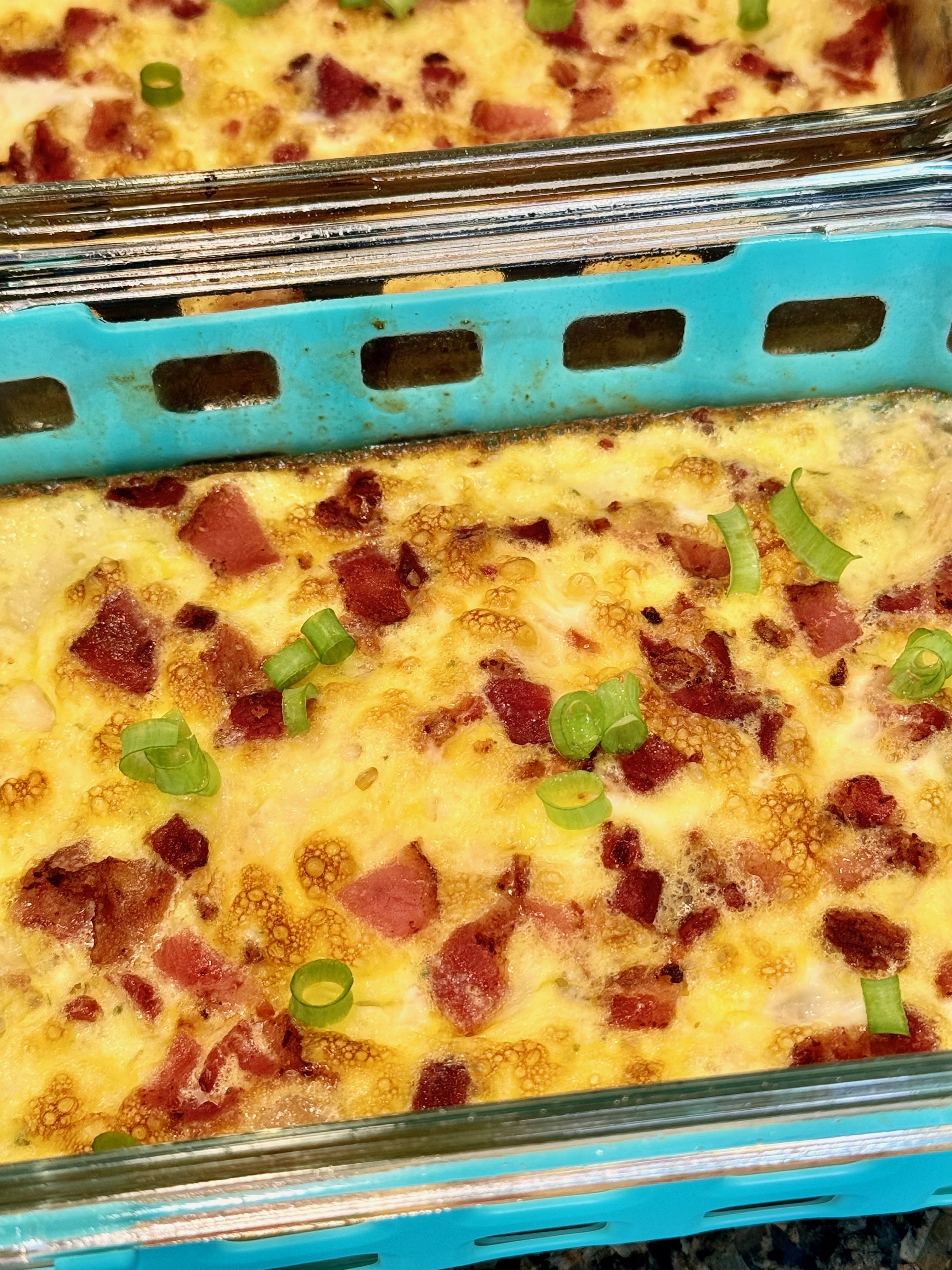 Chicken bacon ranch egg bowl with eggs, cottage cheese, bacon bits, green onion, and cheddar cheese.