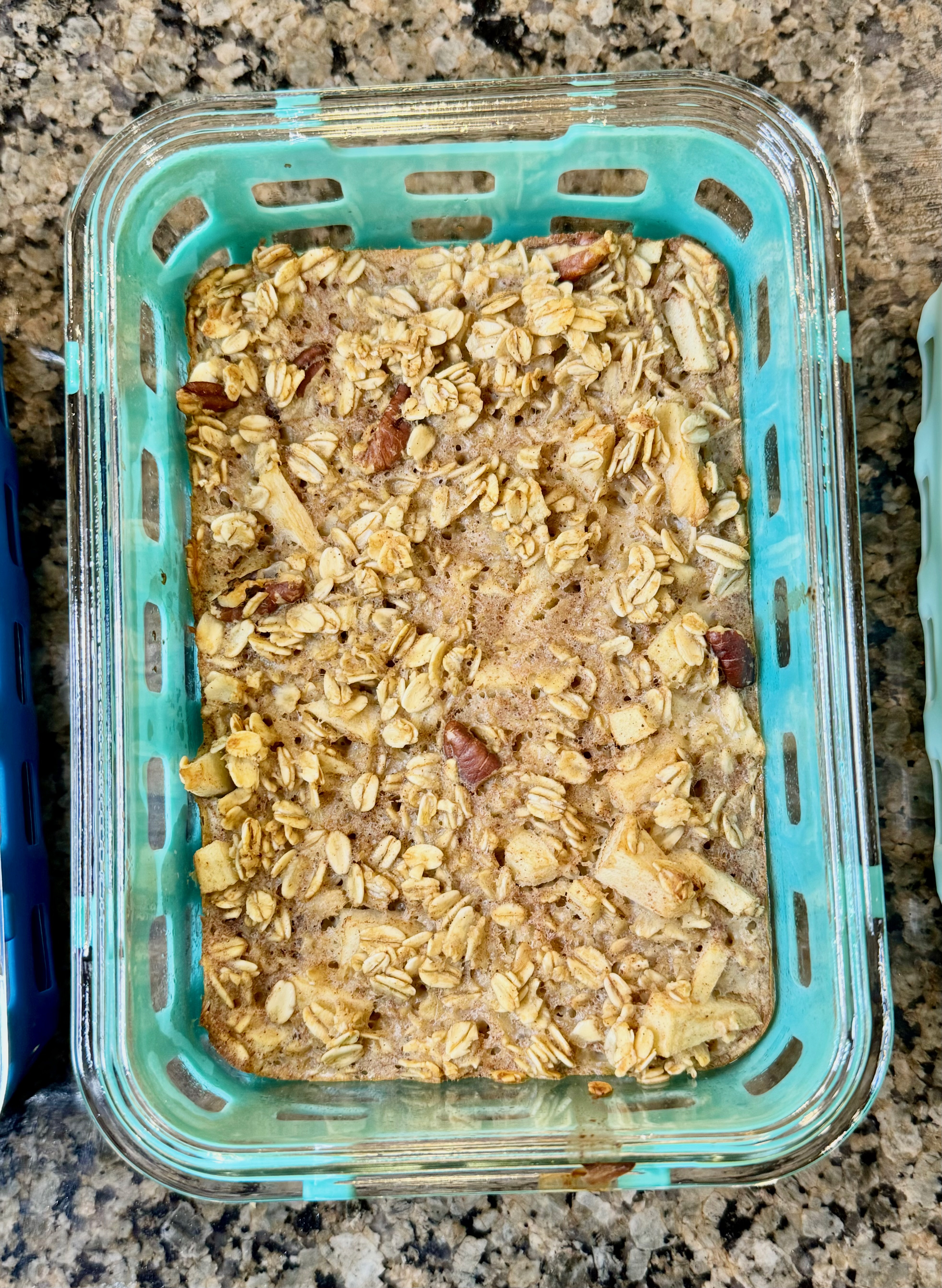 Baked apple cinnamon oatmeal in a glass meal prep container.