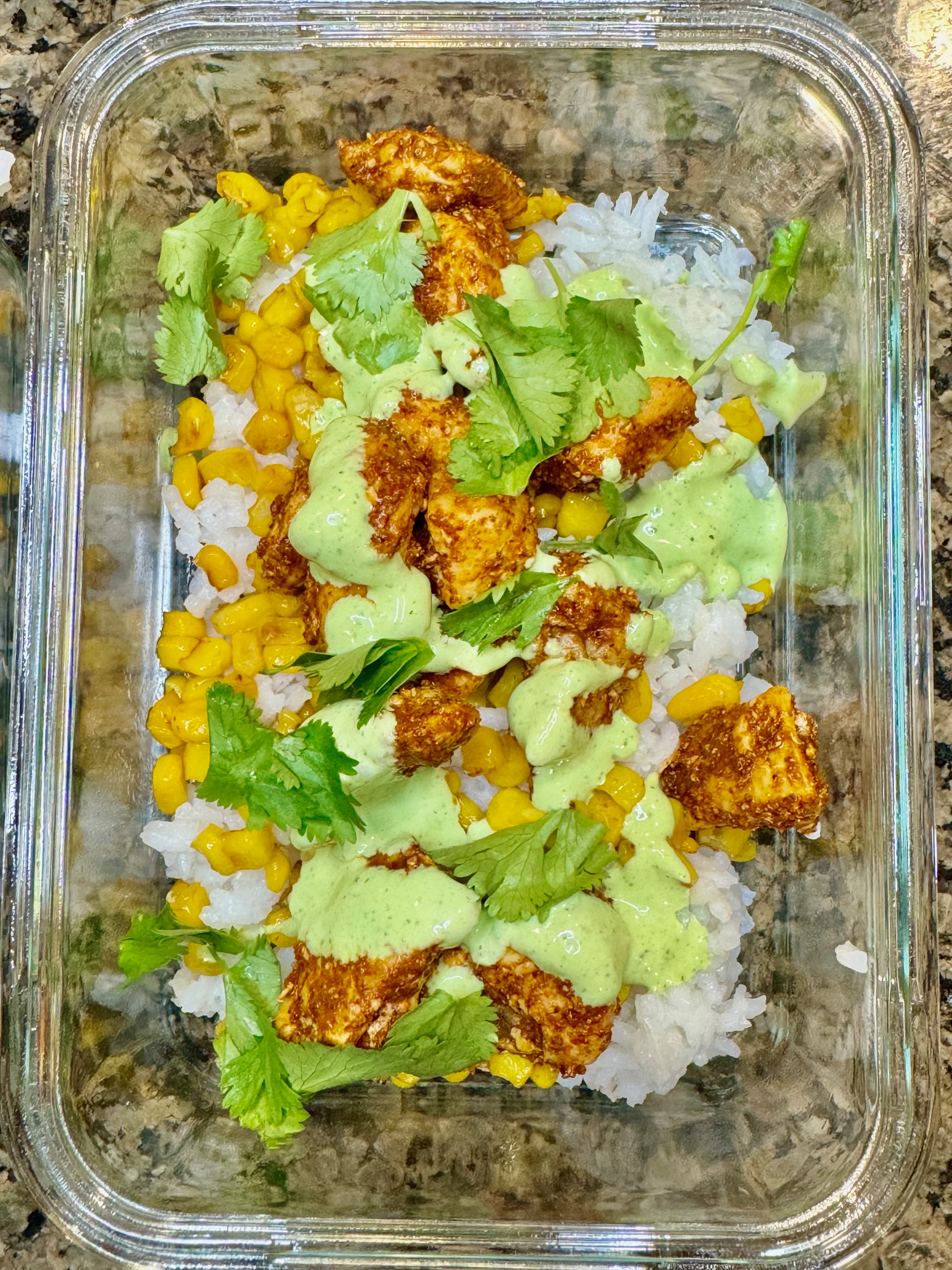 street corn chicken bowl with rice, seasoned chicken, and creamy corn topping