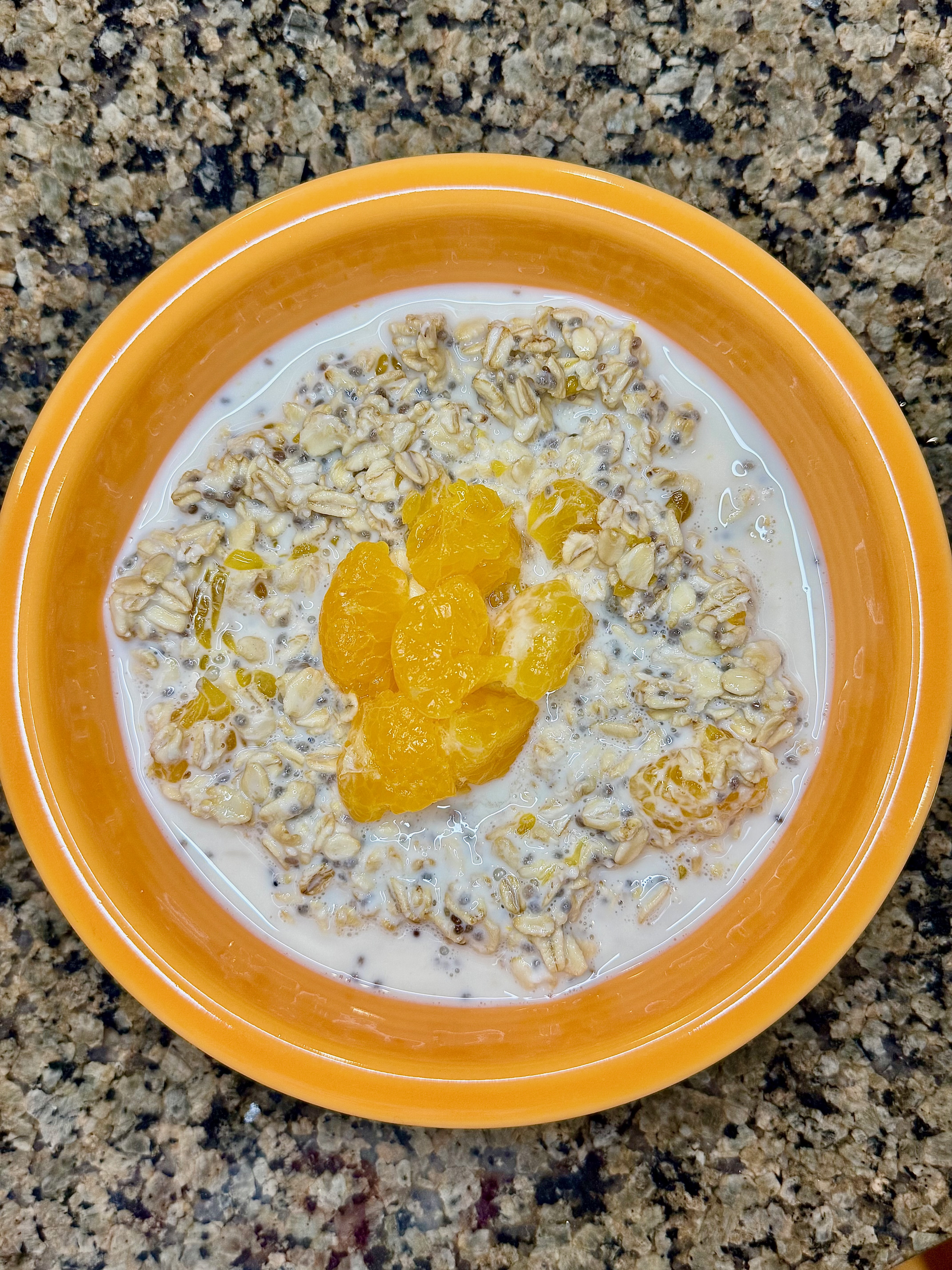 A bowl of creamy creamsicle-flavored overnight oats topped with mandarin oranges.