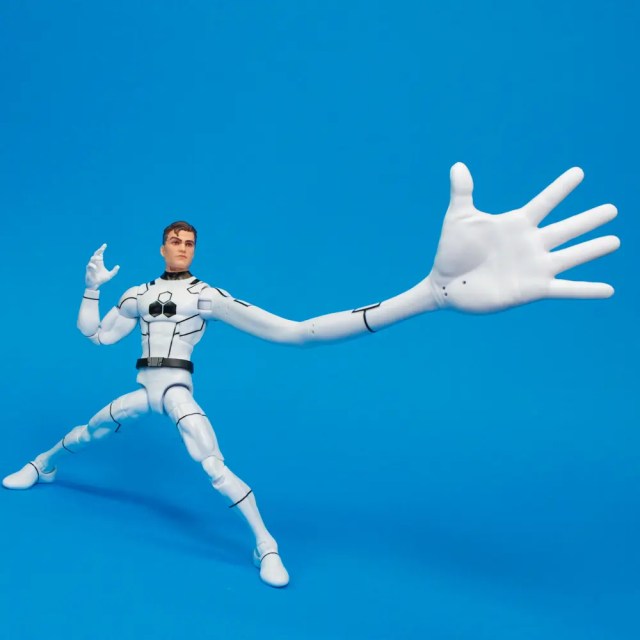 A poseable action figure with one elongated arm, standing against a blue background.