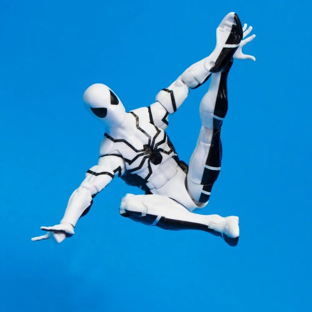 A white and black Spider-Man action figure in a dynamic pose, against a blue background.