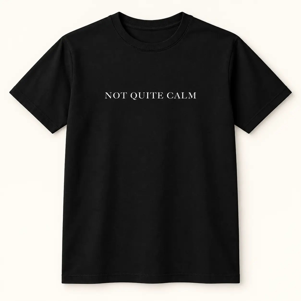 Black T-shirt with white “Not Quite Calm” text across the chest