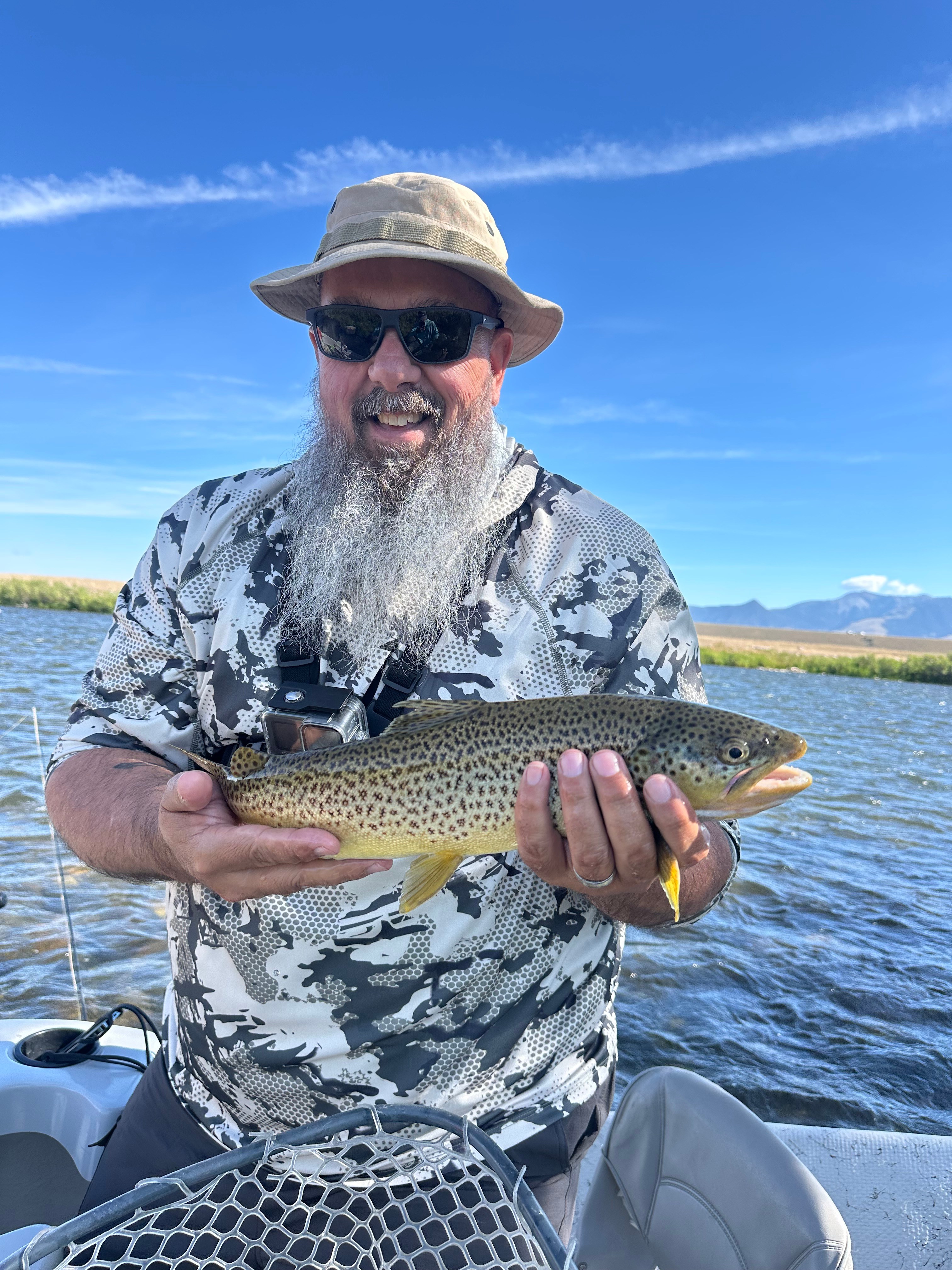 Scott Card bio pic man holding fish in boat