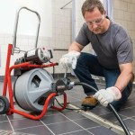 Drain cleaning with a rooter machine