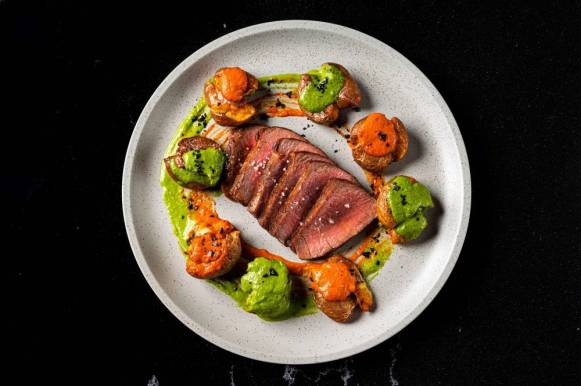 Presa Iberico con Patatas y Mojos (Grilled pork Iberico steak, fried marble potatoes, green and red mojos sauces) from Cantabria Presa Iberico con Patatas y Mojos (Grilled pork Iberico steak, fried marble potatoes, green and red mojos sauces) from Cantabria