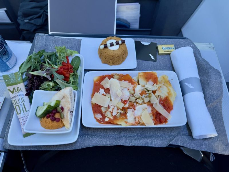 In-flight meal with salad and dessert.