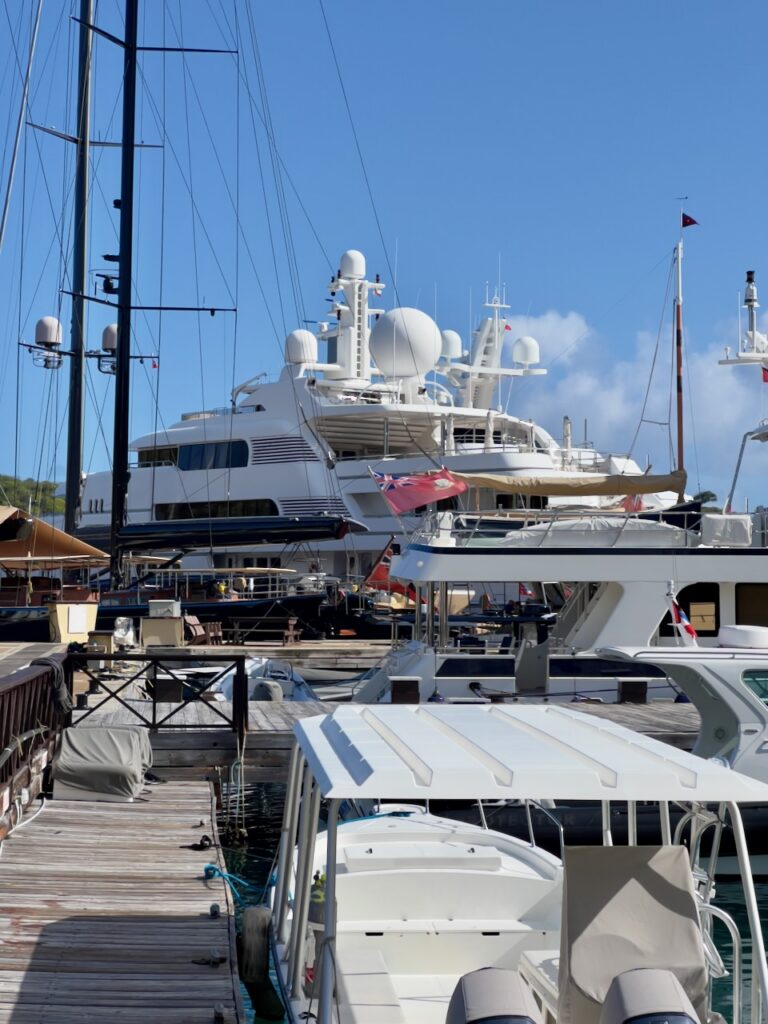Luxury yachts docked at marina.