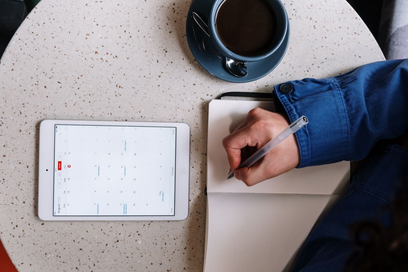 Manager checking a shift schedule on a tablet, illustrating rostering software payroll integration for shift-based teams