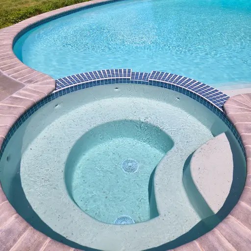 Pool and spa renovation in Connecticut with updated tile, coping, and resurfaced interior