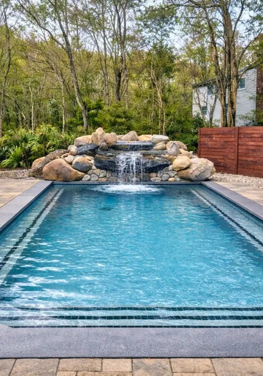 Professional pool builder in CT constructing custom gunite swimming pool with spa and patio