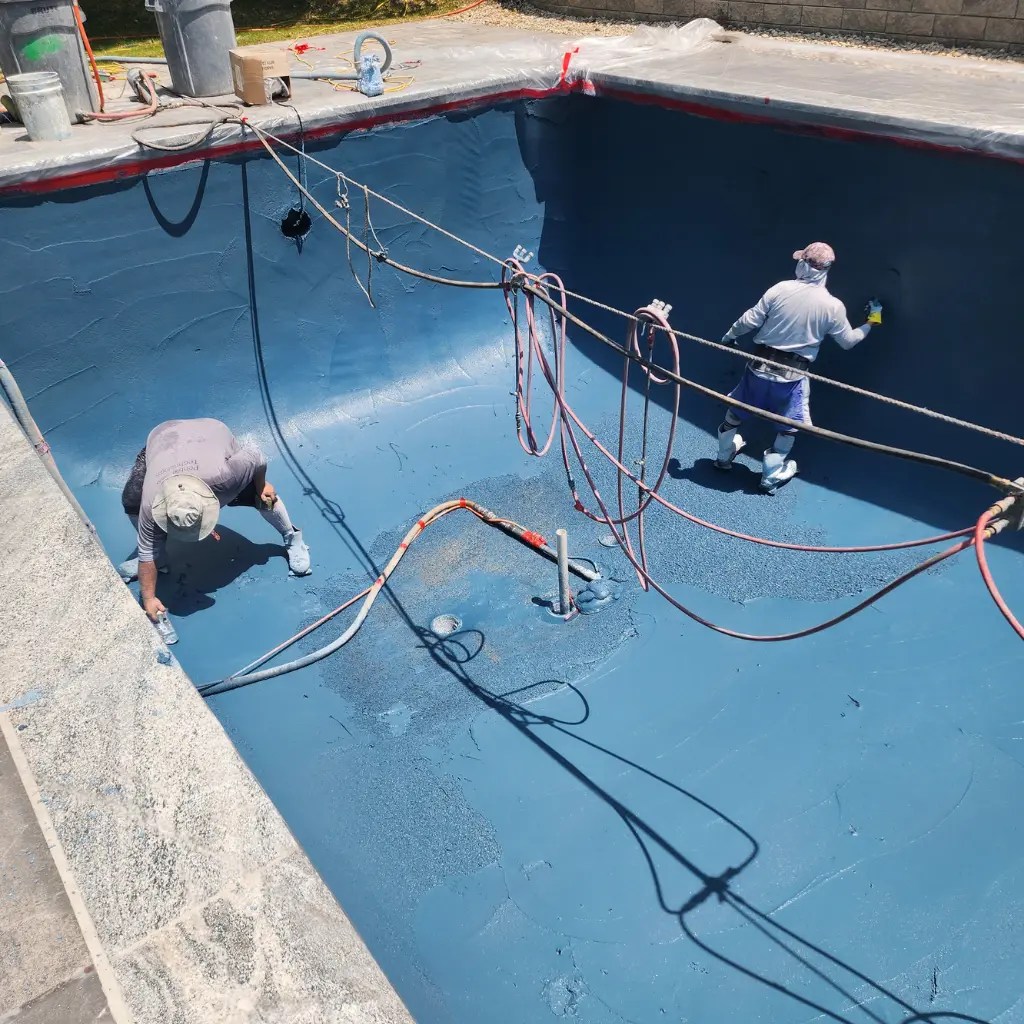 Pool replastering service in Connecticut with fresh blue plaster finish applied inside inground pool