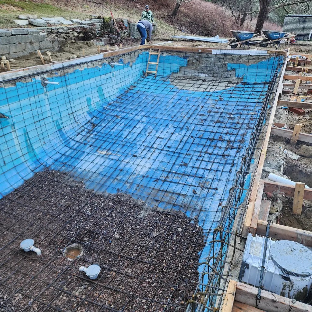 Swimming pool structural repair in Connecticut with exposed rebar and shell preparation before gunite restoration