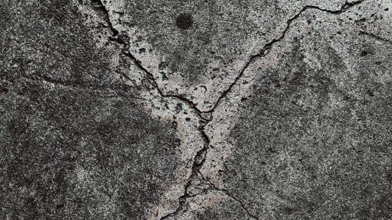 Cracked concrete pavement showing settlement damage