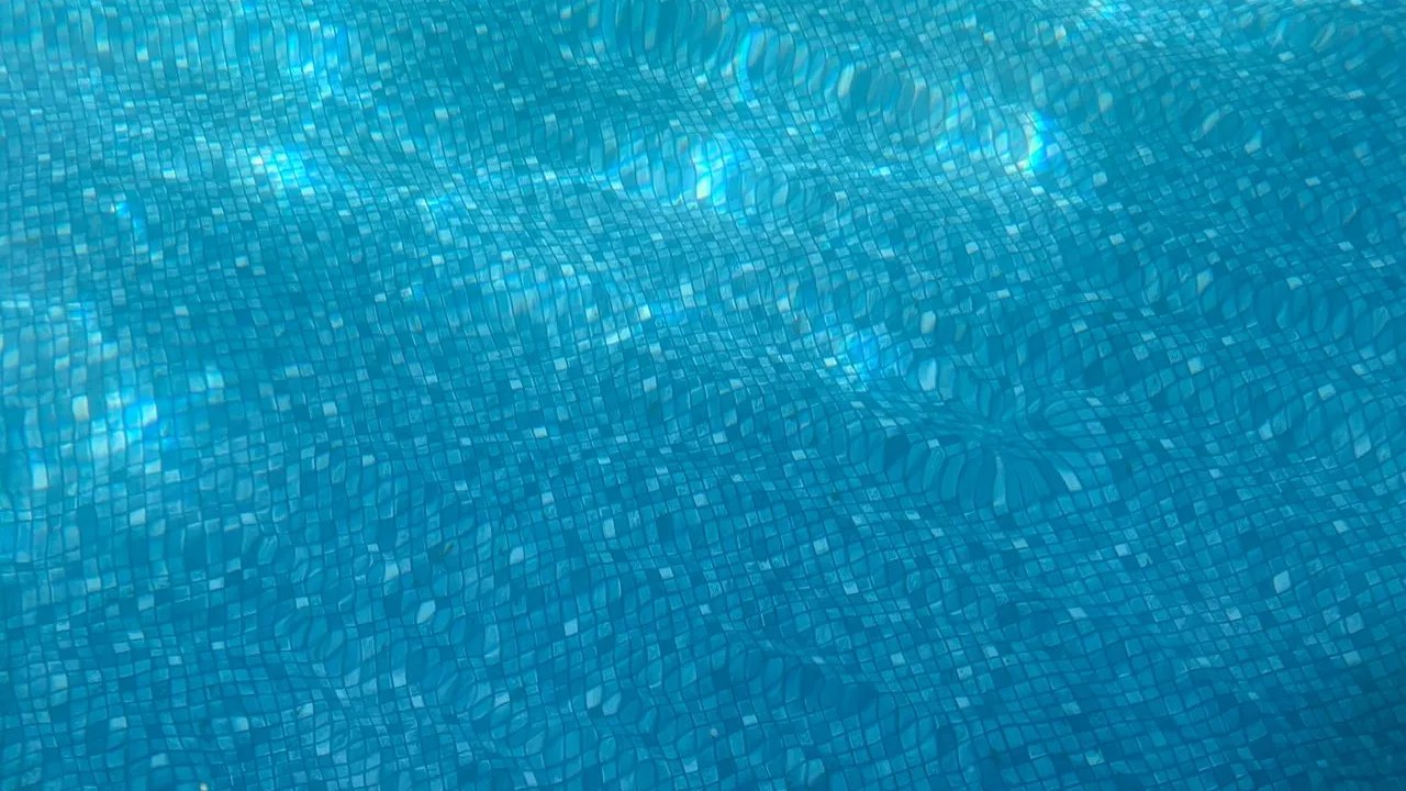 Clear pool water shimmering over a fine aggregate pool finish
