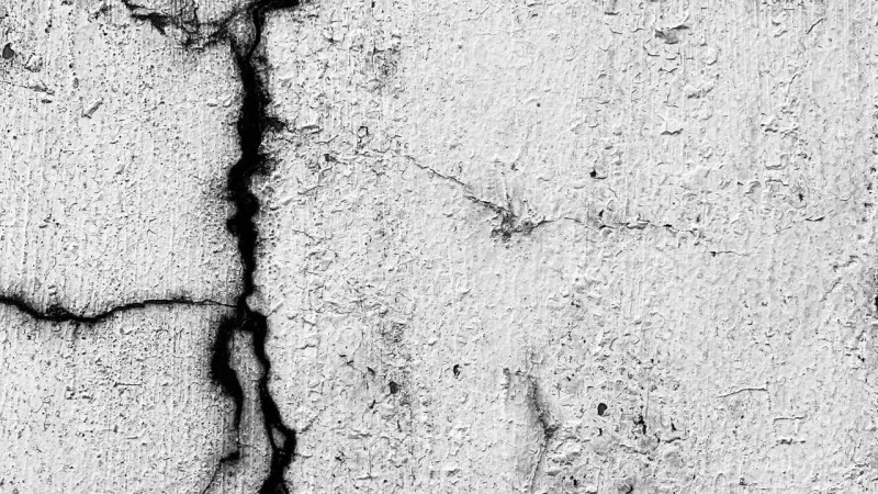 Cracks running across a concrete wall surface