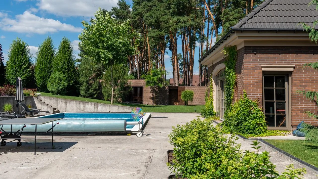 Older backyard pool area with weathered deck before renovation