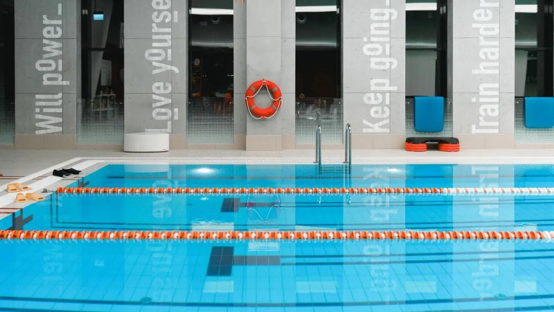 Drained swimming pool with worn interior surface