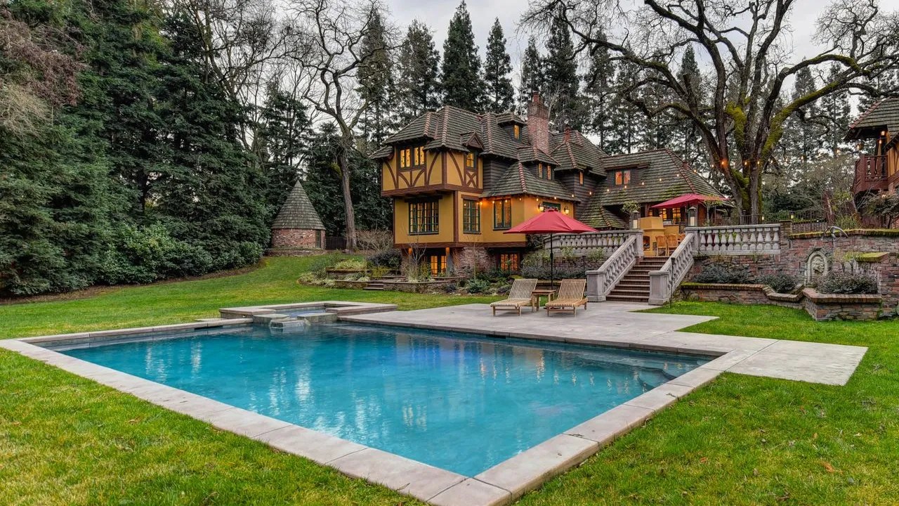 Estate home with large backyard pool and mature trees