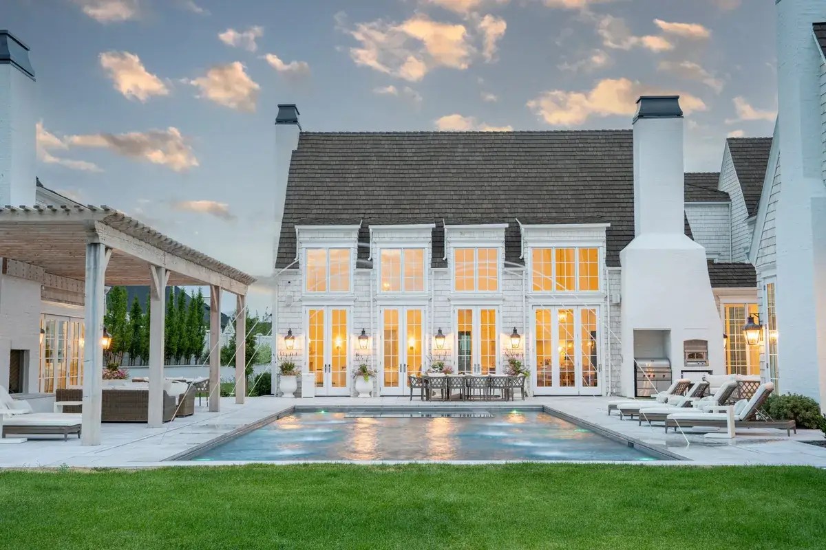 Pool with arching water jets, where automatic pool cover upgrades like a water feature shut-off protect the cover