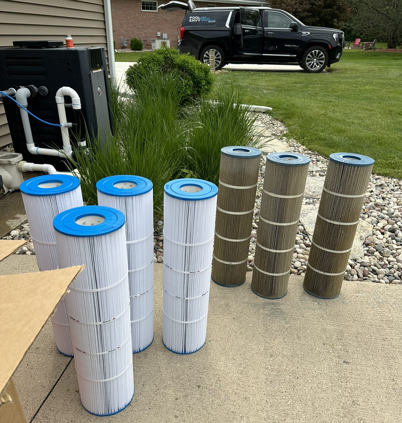 Changing a cartridge filter in Oshkosh WI with Pool Envy truck in background swimming pool service