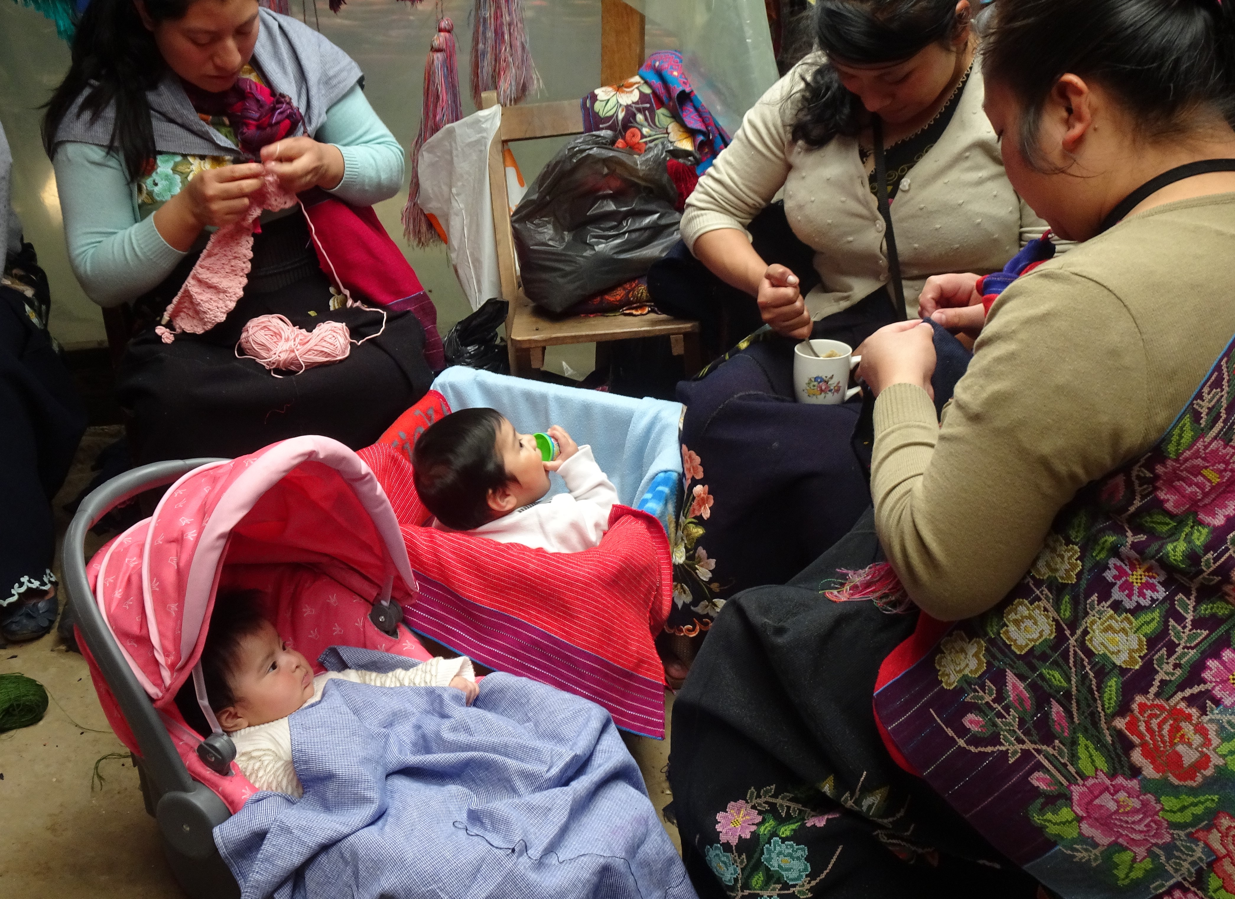 Indigenous Village Zinacantan -- local women embroidering with their babies