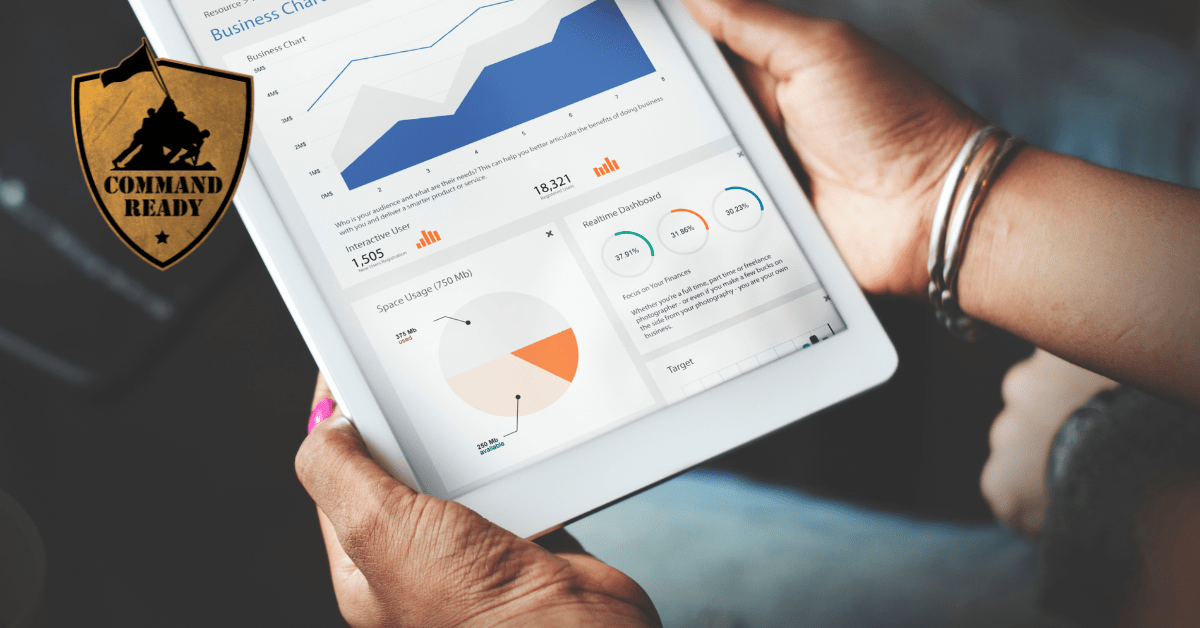 two hands holding a tablet with business metrics and analytics