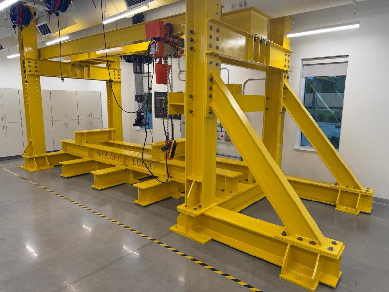 QuakeLogic multi-axis structural testing system with heavy-duty reaction frame and servo-electromechanical actuators