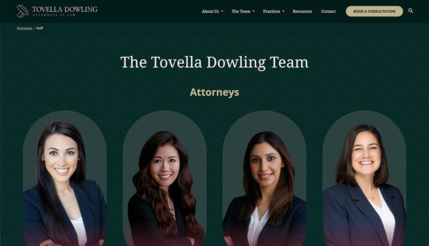 Four women in professional attire are smiling in individual portrait photos against a dark green background. The text above them reads The Tovella Dowling Team Attorneys. The website menu and logo are at the top.