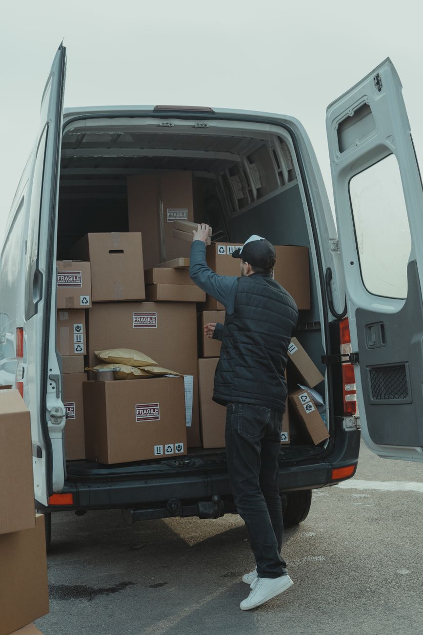 delivery man getting parcels from a van