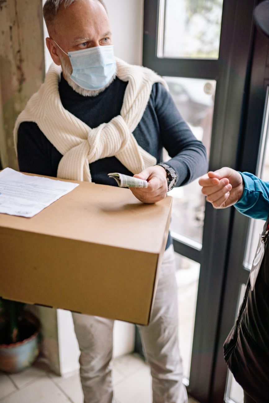 man in sweater receiving a delivery