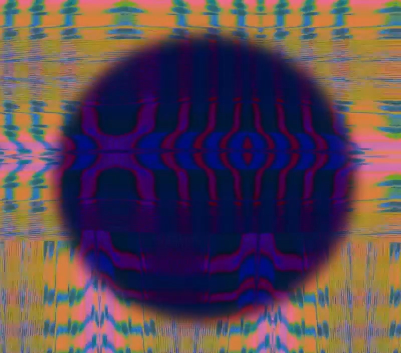 A brightly colored, patterned background with a dark transparent circle magnifying the center.