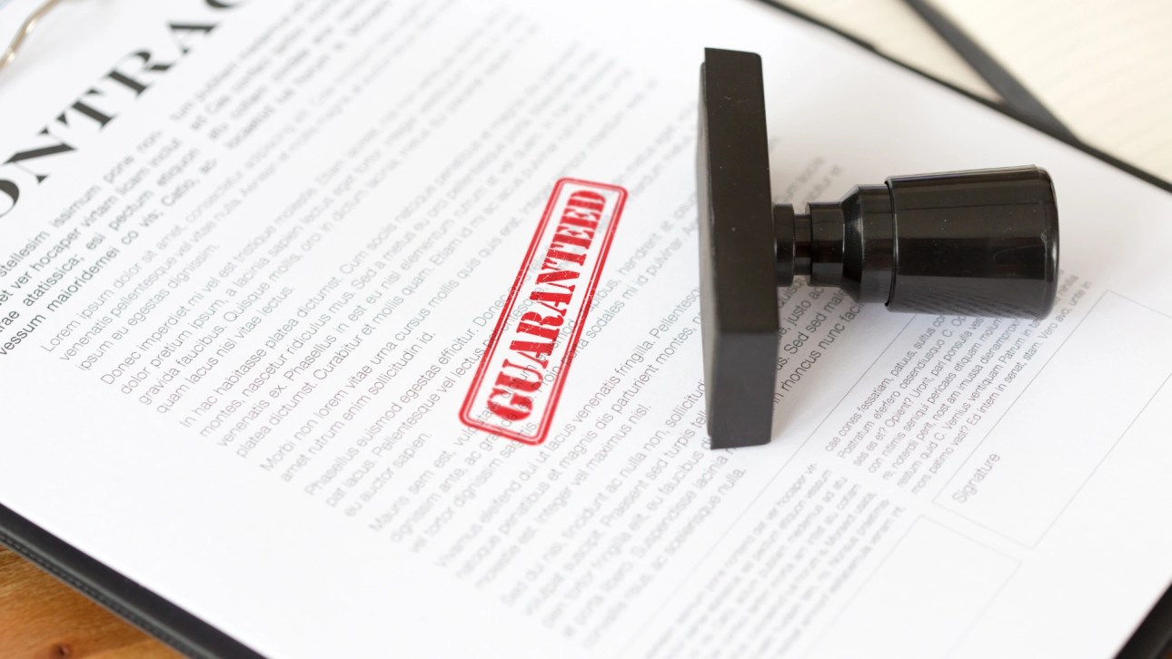 Guarantee in Real Estate- Paperwork with guaranteed stamp