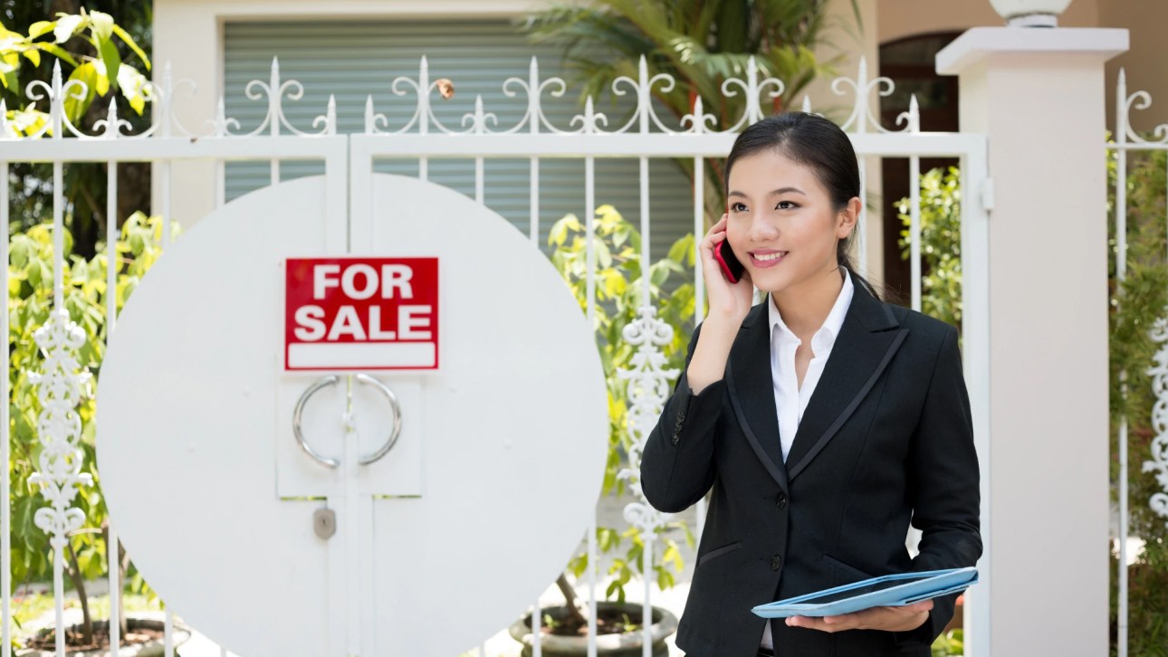 What is an open listing - a top-down view of two professionals reviewing a contract at a white desk
