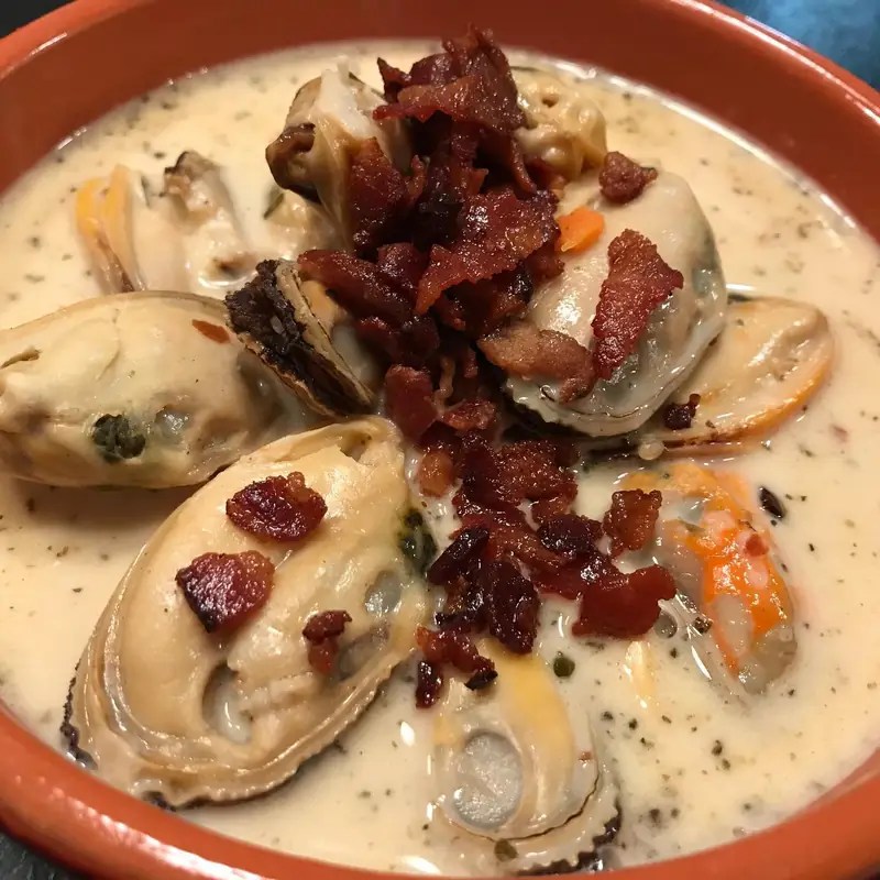Creamy seafood bisque with mussels and crumbled bacon
