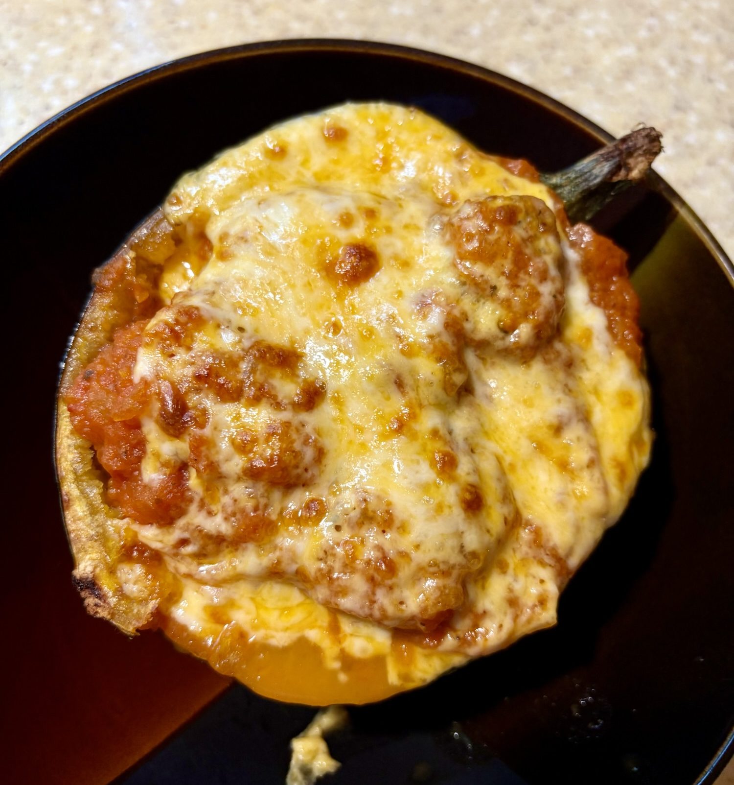 Meatball-Stuffed Acorn Squash, topped with melty cheese