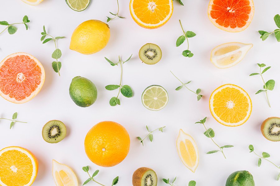 Fundo branco com frutas c&iacute;tricas e ervas distribu&iacute;das em padr&atilde;o